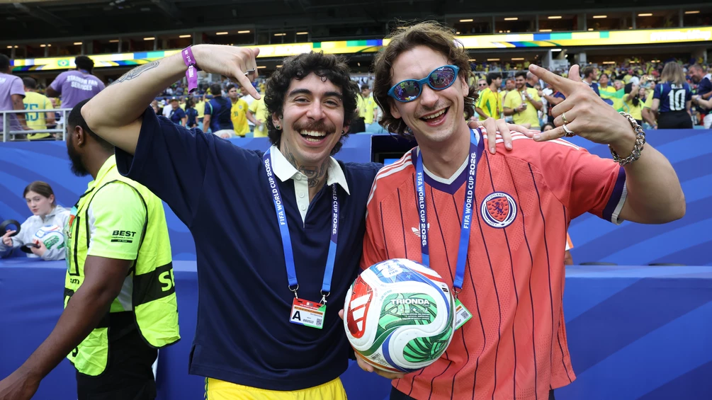 Mochakk and Barry Can’t Swim carry official game ball onto pitch for Brazil vs Scotland World Cup showdown.